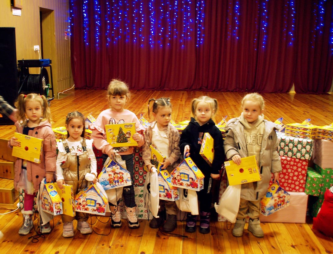 Ukrainian children holding the Christmas presents we sent